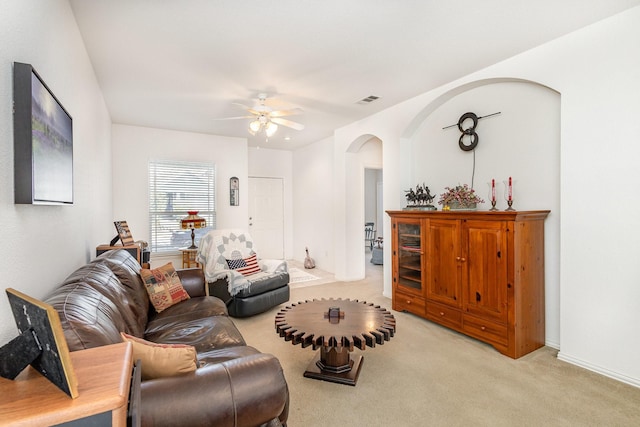 carpeted living room with ceiling fan