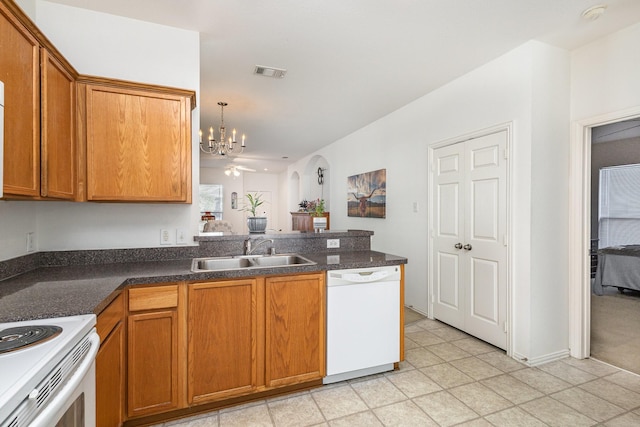 kitchen with sink, a notable chandelier, white appliances, and hanging light fixtures