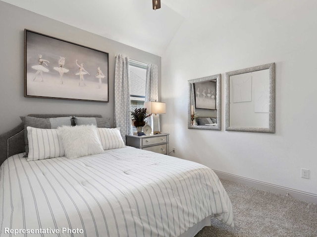 carpeted bedroom featuring lofted ceiling