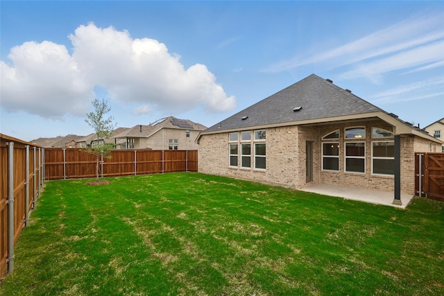 16213 Hidden Cove Dr, Celina, TX 75009 - back of property featuring a fenced backyard, a lawn, a patio area, and brick siding