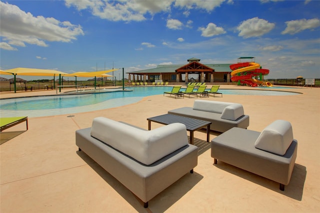 view of pool featuring a gazebo, a patio, an outdoor living space, and a water slide