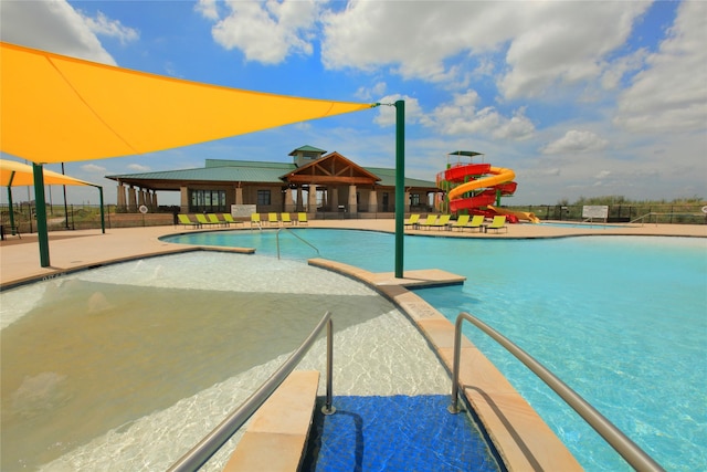 view of swimming pool featuring a patio area and a water slide