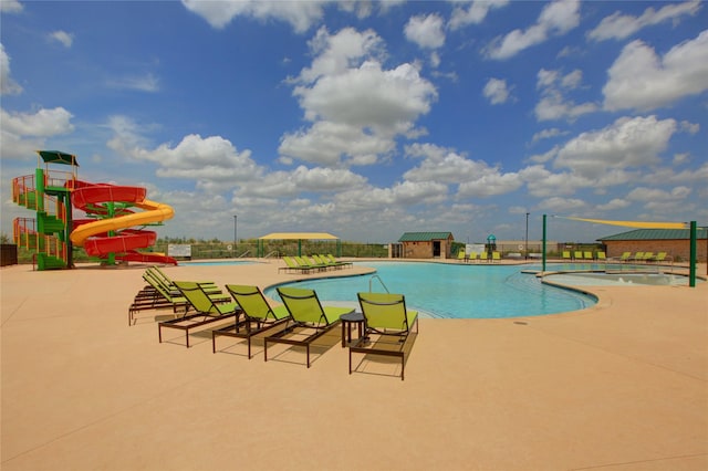 view of swimming pool featuring a patio and a water slide