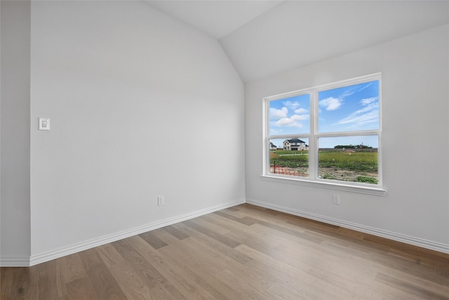 16213 Hidden Cove Dr, Celina, TX 75009 - empty room featuring baseboards, vaulted ceiling, and wood finished floors