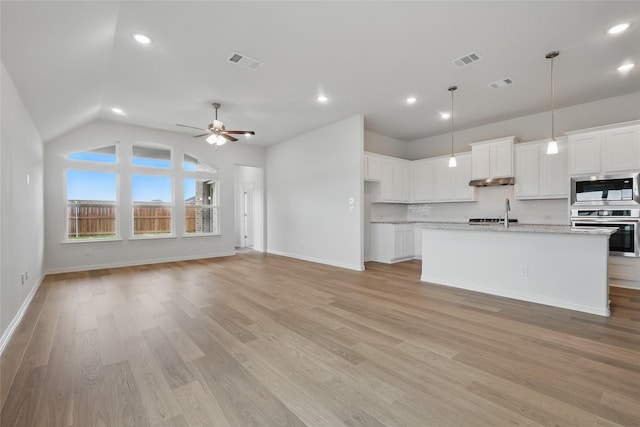 16213 Hidden Cove Dr, Celina, TX 75009 - kitchen with appliances with stainless steel finishes, vaulted ceiling, and visible vents