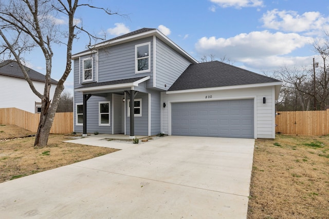 front of property featuring a garage and a front lawn