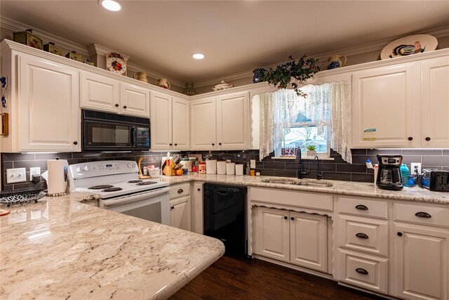 kitchen featuring white cabinetry, sink, light stone counters, and black appliances