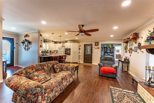 living room featuring dark wood-type flooring, ceiling fan, and ornamental molding