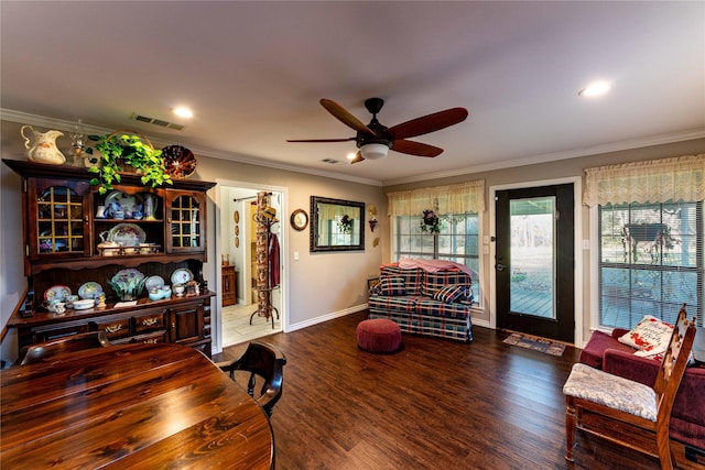 living room featuring ornamental molding, dark wood-type flooring, and ceiling fan