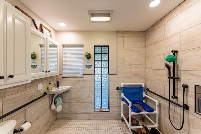 bathroom with tile walls and sink