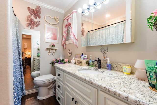 bathroom with vanity, wood-type flooring, ornamental molding, and toilet