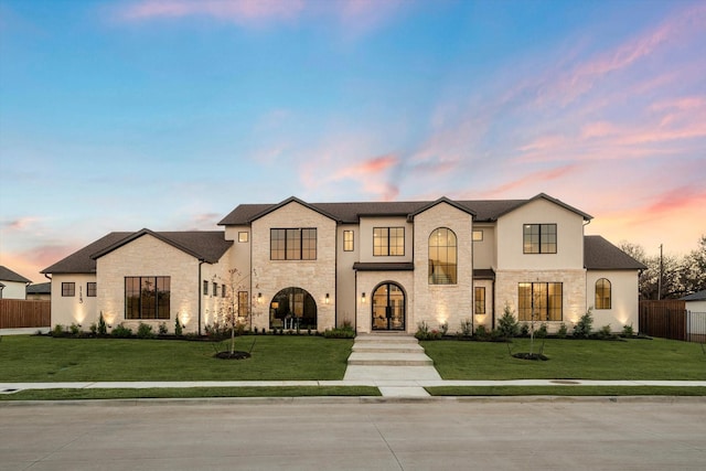 french provincial home featuring a lawn