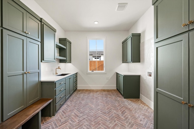 interior space with cabinets, sink, and hookup for a washing machine