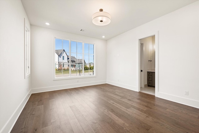 unfurnished room featuring dark wood-type flooring