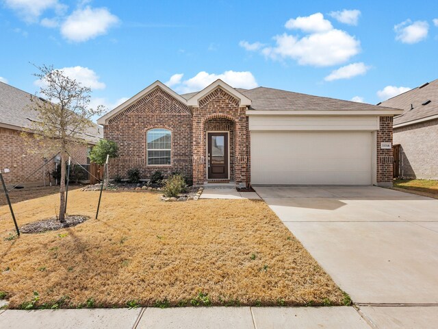 view of front facade with a front yard and a garage