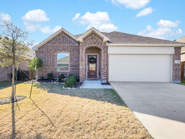 view of front of house with a garage and a front lawn