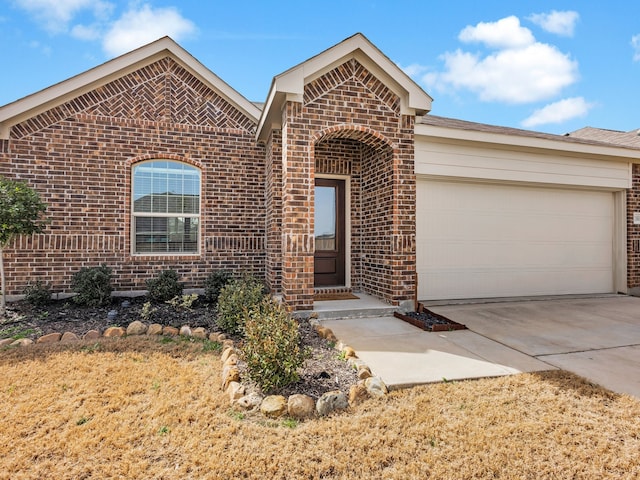 ranch-style home featuring an attached garage, concrete driveway, and brick siding