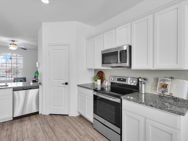 kitchen featuring white cabinetry, ceiling fan, stainless steel appliances, and light wood-type flooring