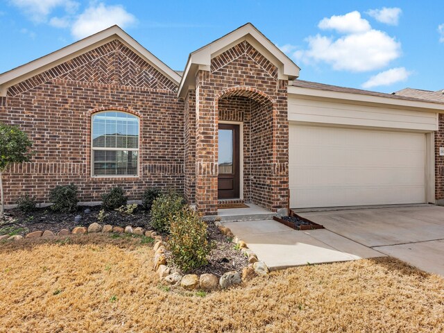 view of front of property with a front yard and a garage