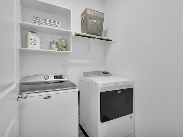 washroom featuring laundry area and separate washer and dryer