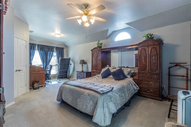 bedroom with light colored carpet, vaulted ceiling, and ceiling fan