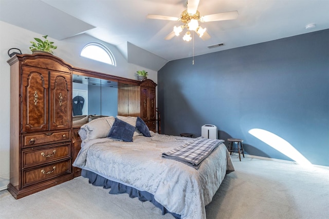 bedroom featuring ceiling fan, light colored carpet, and vaulted ceiling