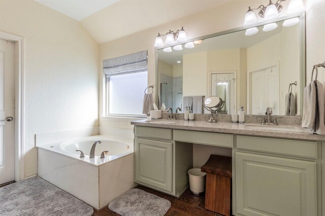 bathroom with wood-type flooring, vanity, independent shower and bath, and lofted ceiling