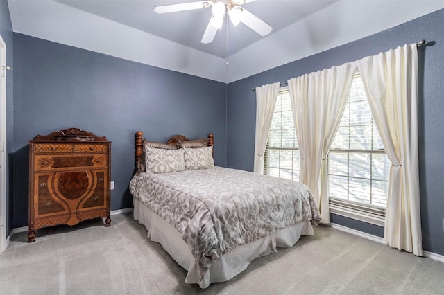 bedroom featuring light colored carpet, multiple windows, and ceiling fan