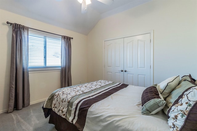 carpeted bedroom with a closet, vaulted ceiling, and ceiling fan