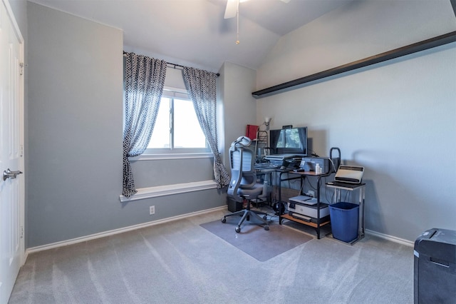 carpeted home office with ceiling fan and vaulted ceiling