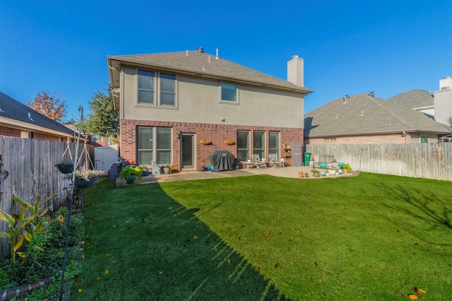 rear view of property with a patio area and a yard