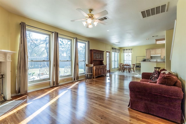 living room featuring light wood-type flooring and ceiling fan