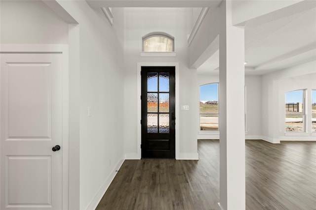 entryway featuring dark wood-type flooring and baseboards