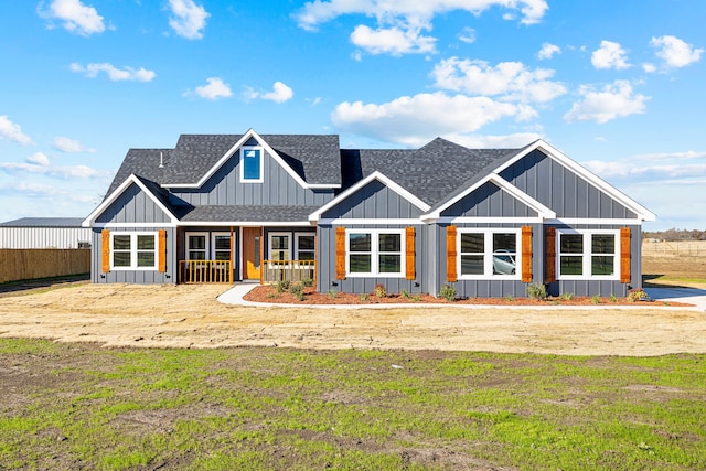 view of front of home featuring covered porch and a front lawn