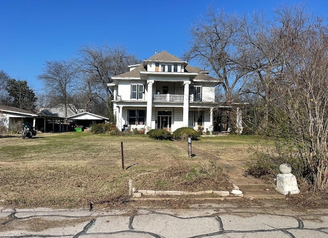 neoclassical home featuring covered porch and a front yard