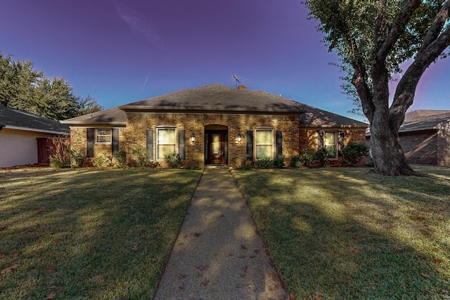 ranch-style house featuring a lawn