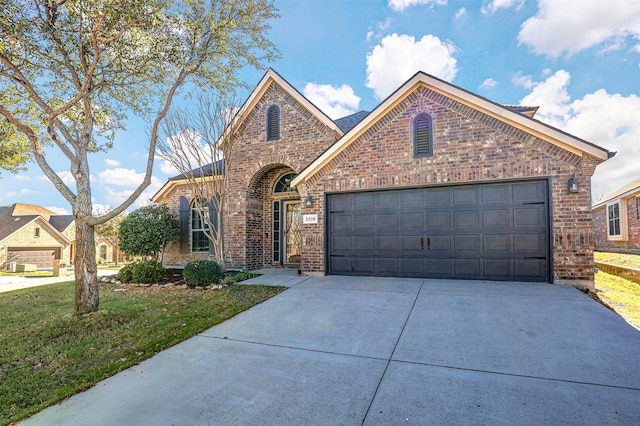 view of property featuring a front lawn and a garage