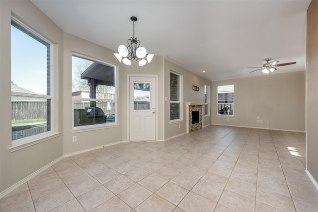 unfurnished living room with ceiling fan with notable chandelier, light tile patterned flooring, and crown molding