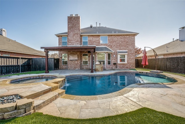 view of pool featuring an in ground hot tub, pool water feature, and a patio area