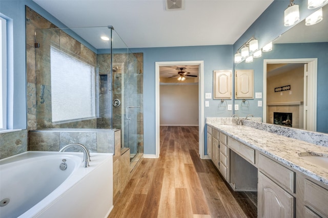 bathroom featuring separate shower and tub, ceiling fan, vanity, and wood-type flooring