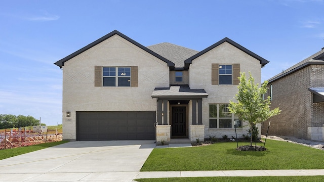 view of front facade featuring driveway, a front lawn, and a garage