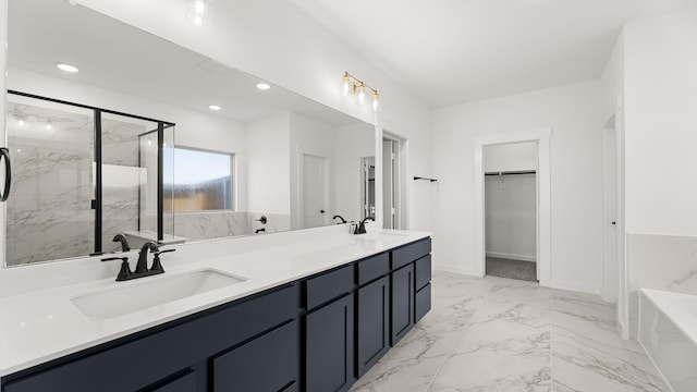 full bathroom with a sink, a tub to relax in, a marble finish shower, a spacious closet, and marble finish floor