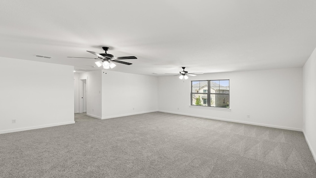 unfurnished room with a ceiling fan, visible vents, carpet floors, and baseboards