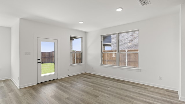 empty room with visible vents, recessed lighting, light wood-style flooring, and baseboards