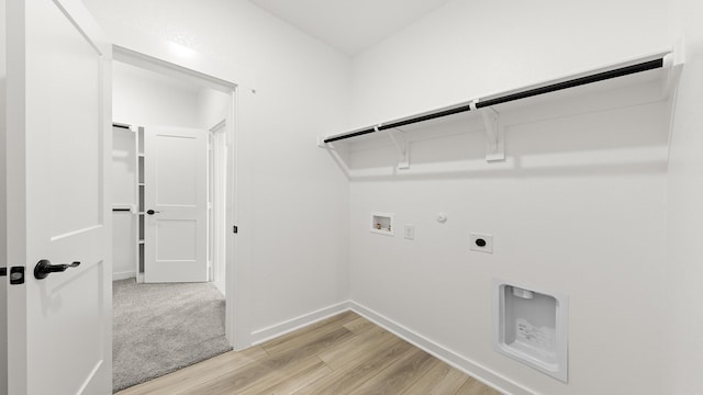 laundry area with hookup for a washing machine, laundry area, hookup for an electric dryer, hookup for a gas dryer, and light wood-type flooring