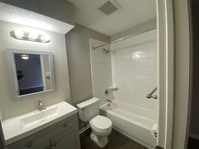 full bathroom with vanity, toilet, and tiled shower / bath