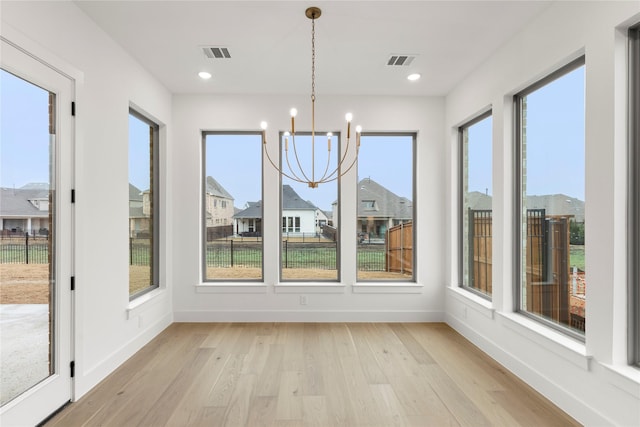 unfurnished sunroom featuring a notable chandelier