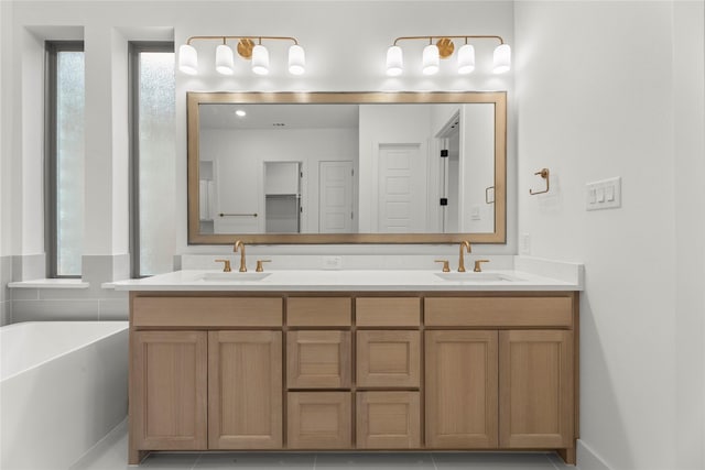 bathroom featuring vanity, a healthy amount of sunlight, and a washtub