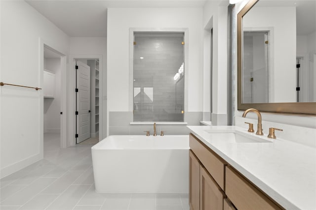 2671 Pelican Pt, Prosper, TX 75078 - bathroom with a freestanding tub, a tile shower, vanity, a spacious closet, and tile patterned floors