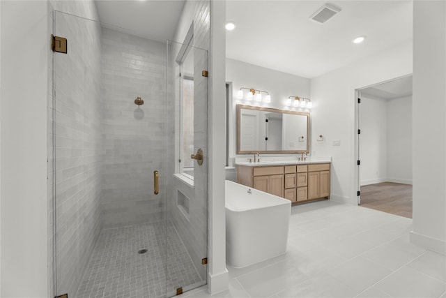 bathroom with vanity, independent shower and bath, and tile patterned flooring